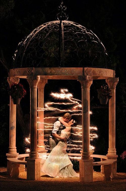 newlyweds kissing in light circles