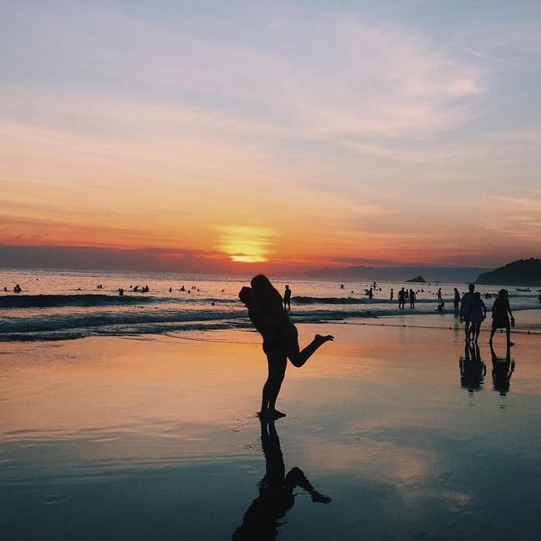 happy couple on the beach at sunset