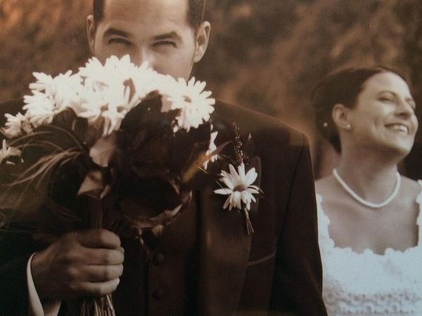 man giving his wife flowers at the wedding