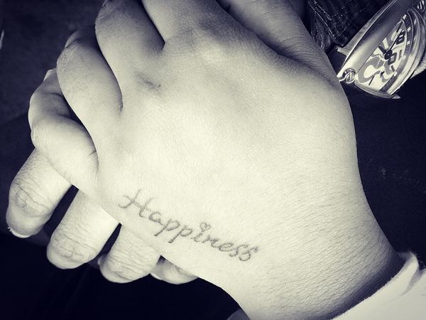 happiness tattoo text on hand