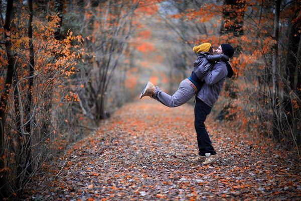 young people hugging in the autumn park